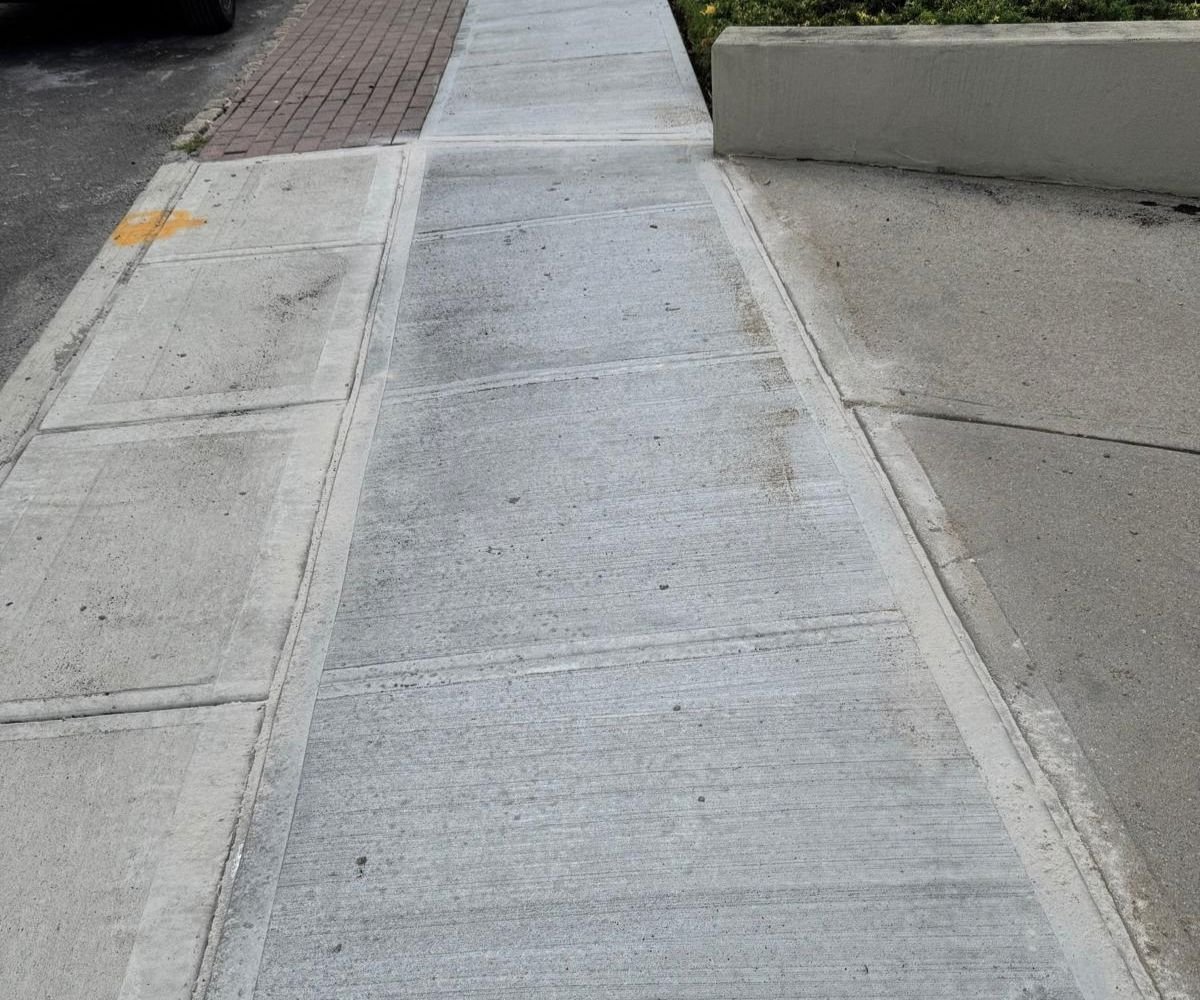 Newly replaced concrete sidewalk at a Jamaica, Queens home