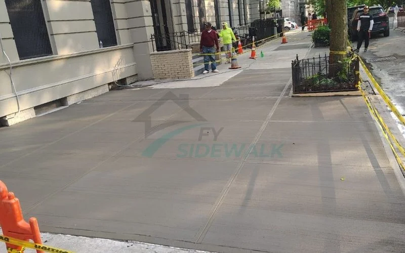 new concrete sidewalk repair outside a bronx property