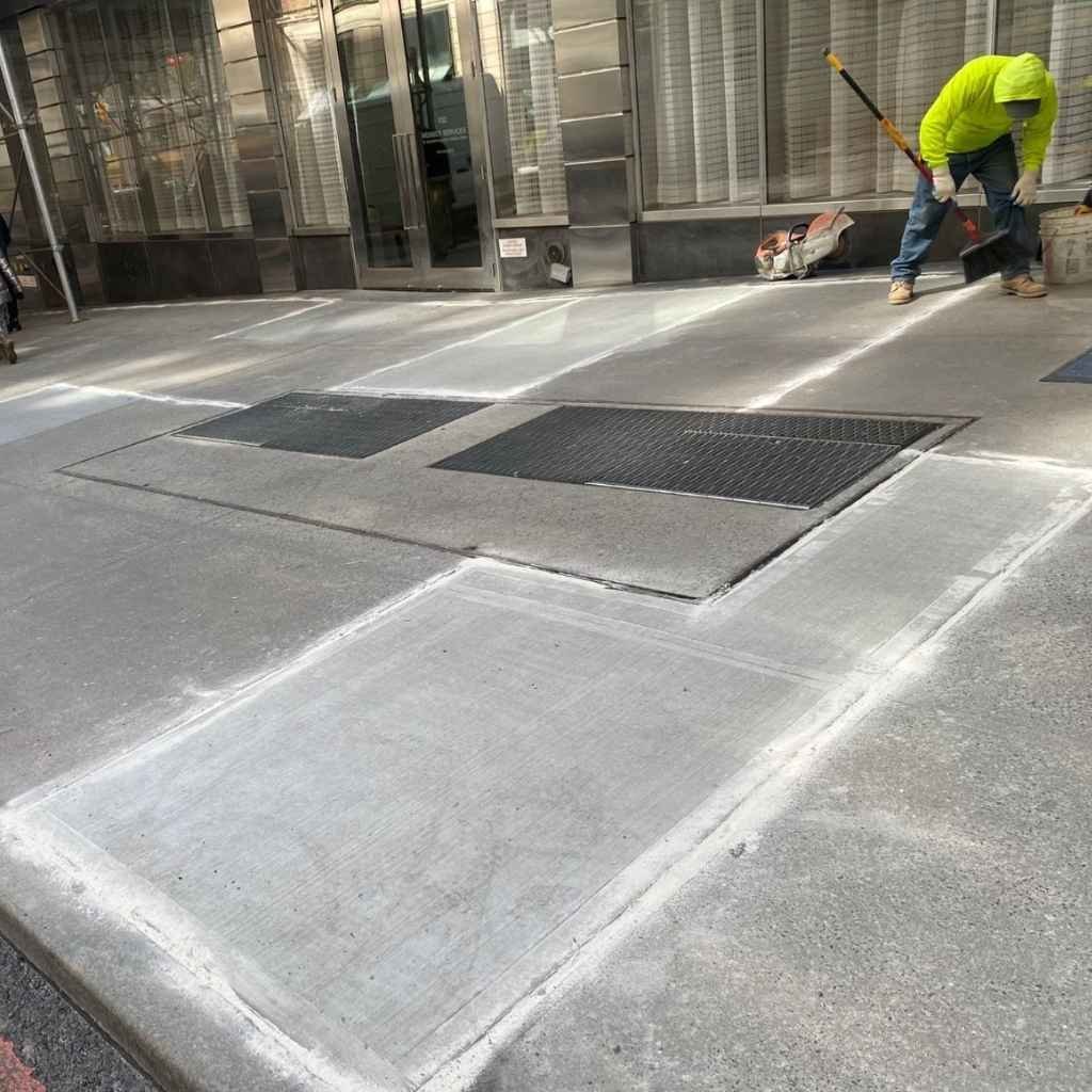 newly repaired sidewalk outside a manhattan property after dot violation correction