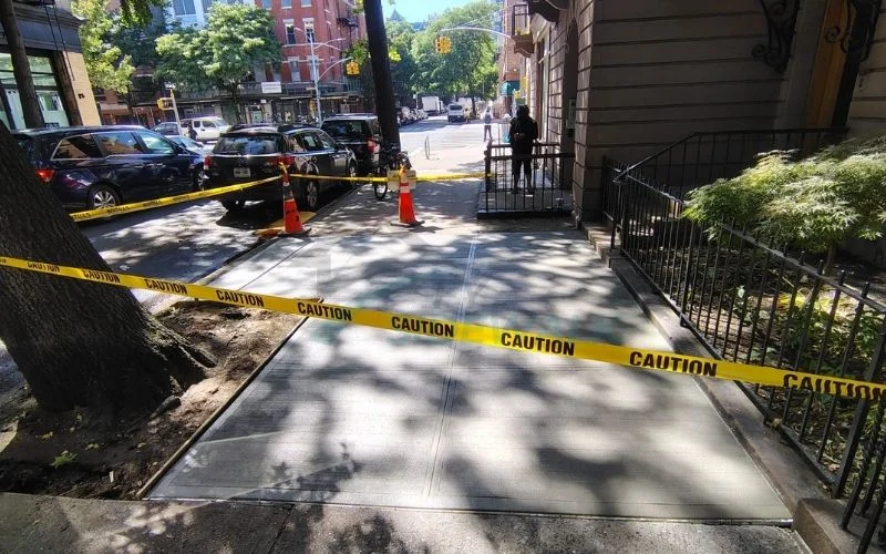 new concrete sidewalk finished outside a manhattan building