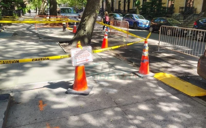 sidewalk repair area blocked off with cones in manhattan