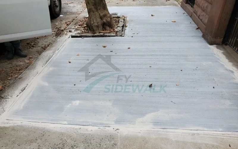new concrete sidewalk repaired around a street tree in brooklyn