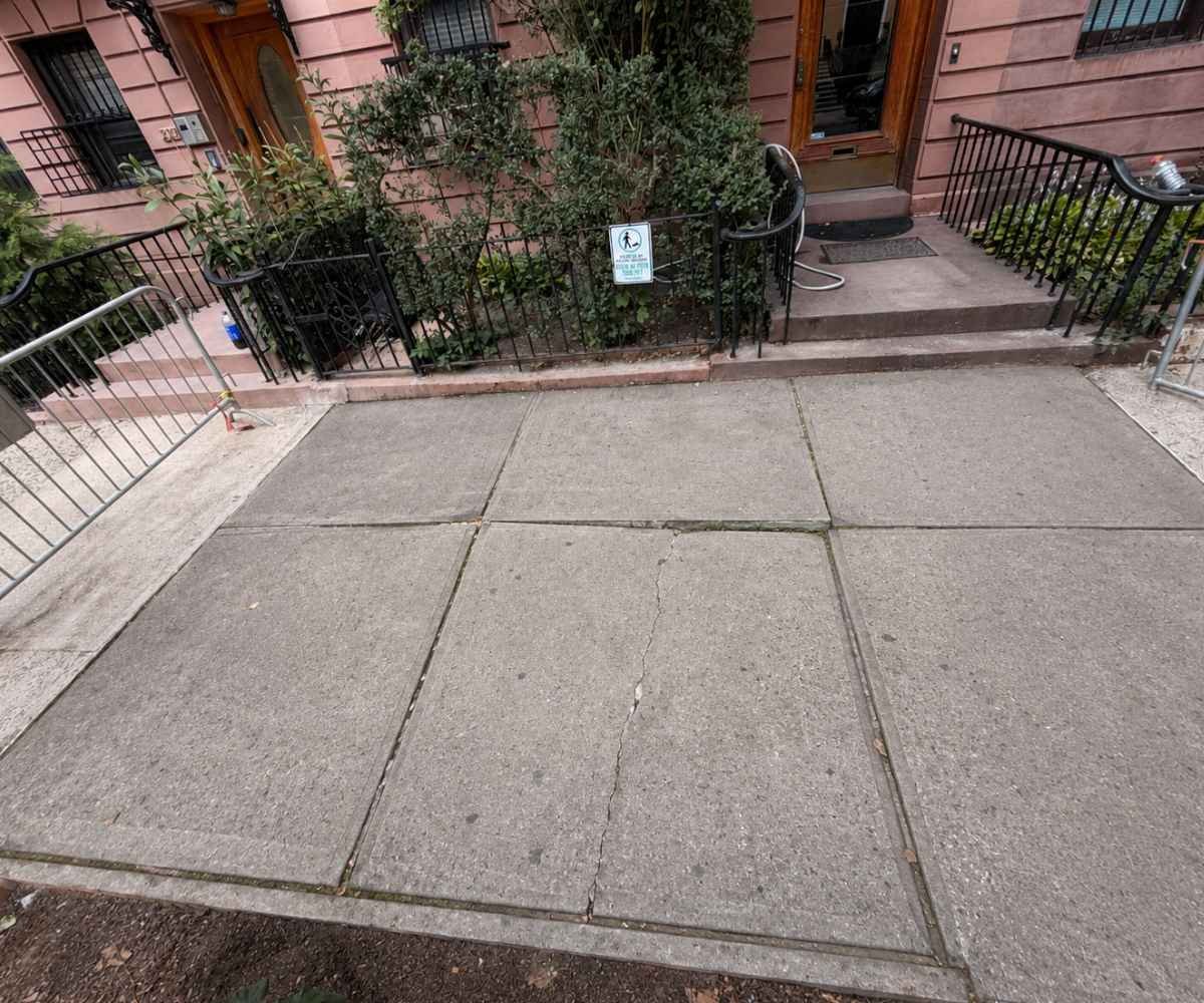 dot sidewalk violation on uneven concrete slabs