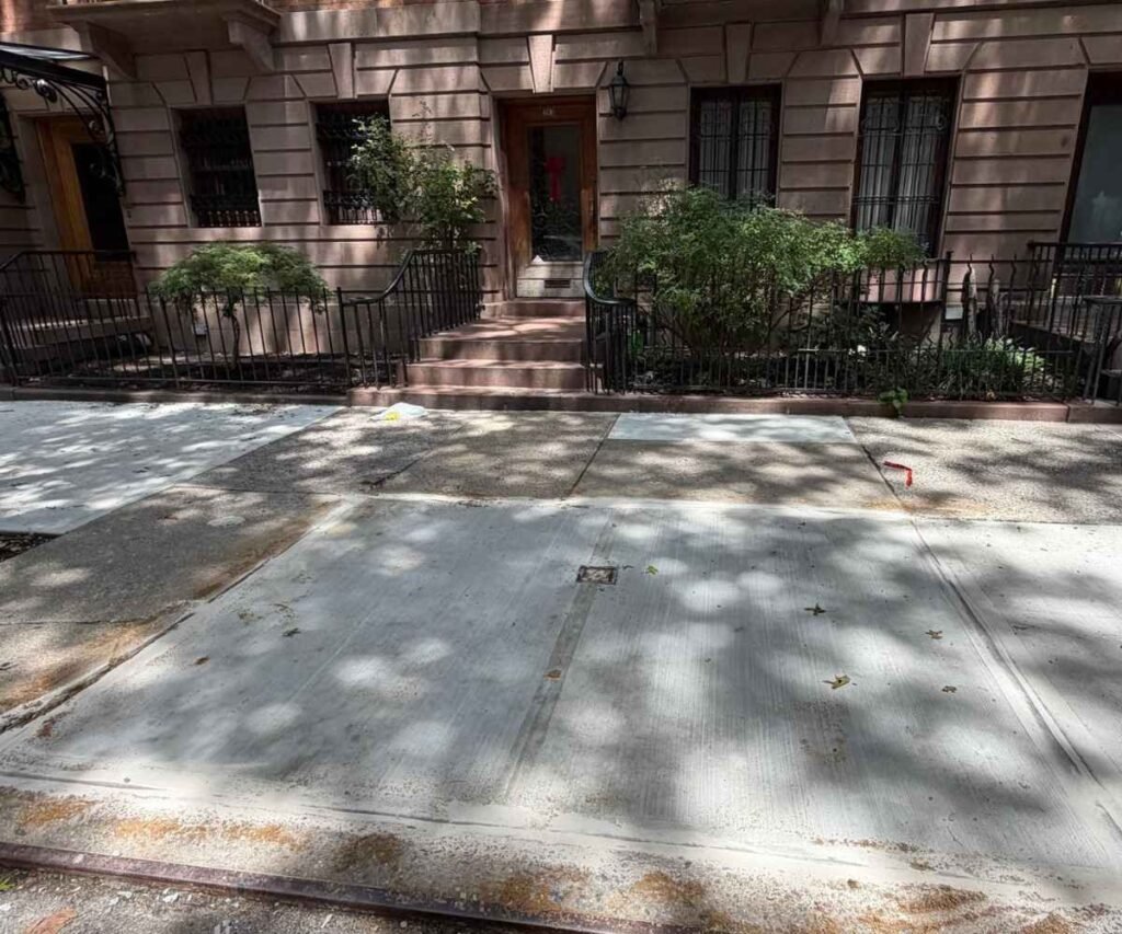 Completed concrete sidewalk replacement at 263 W 139th St on Strivers' Row in New York City.